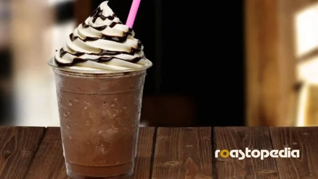 a frappuccino in a paper cup with a straw ready to drink