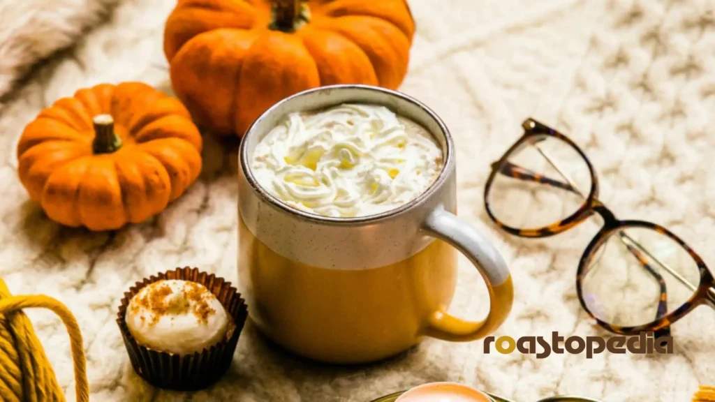 a cup of Pumpkin spice latte, glasses, and whole pumpkins